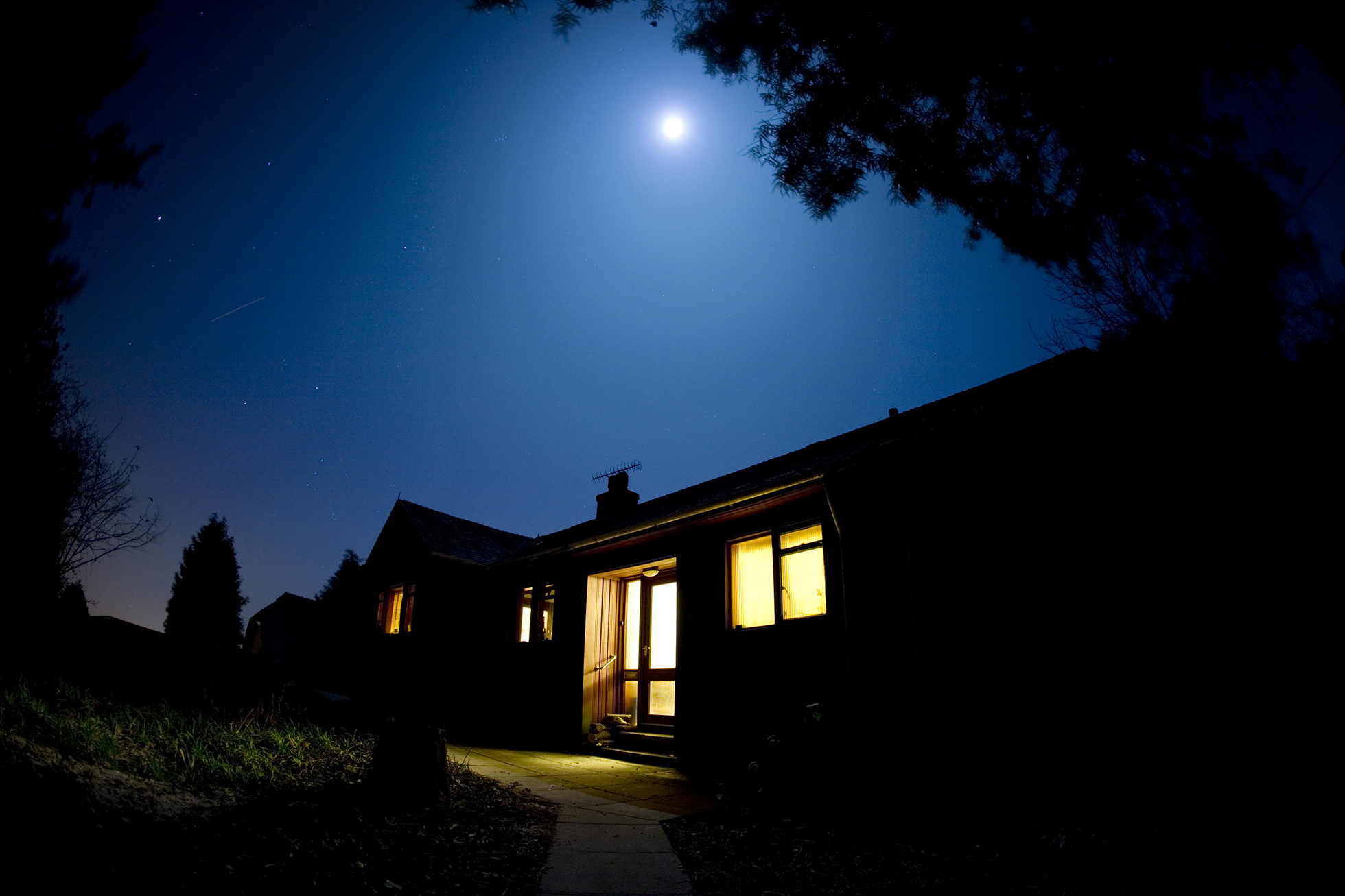 Silhouette of home at night | Stop watering lawns in morning