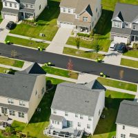 Aerial shot of suburban housing on a sunny day.