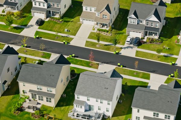 Aerial shot of suburban housing on a sunny day.
