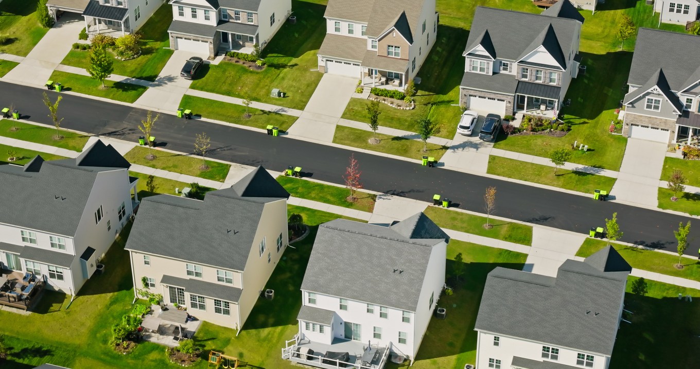 Aerial shot of suburban housing on a sunny day.
