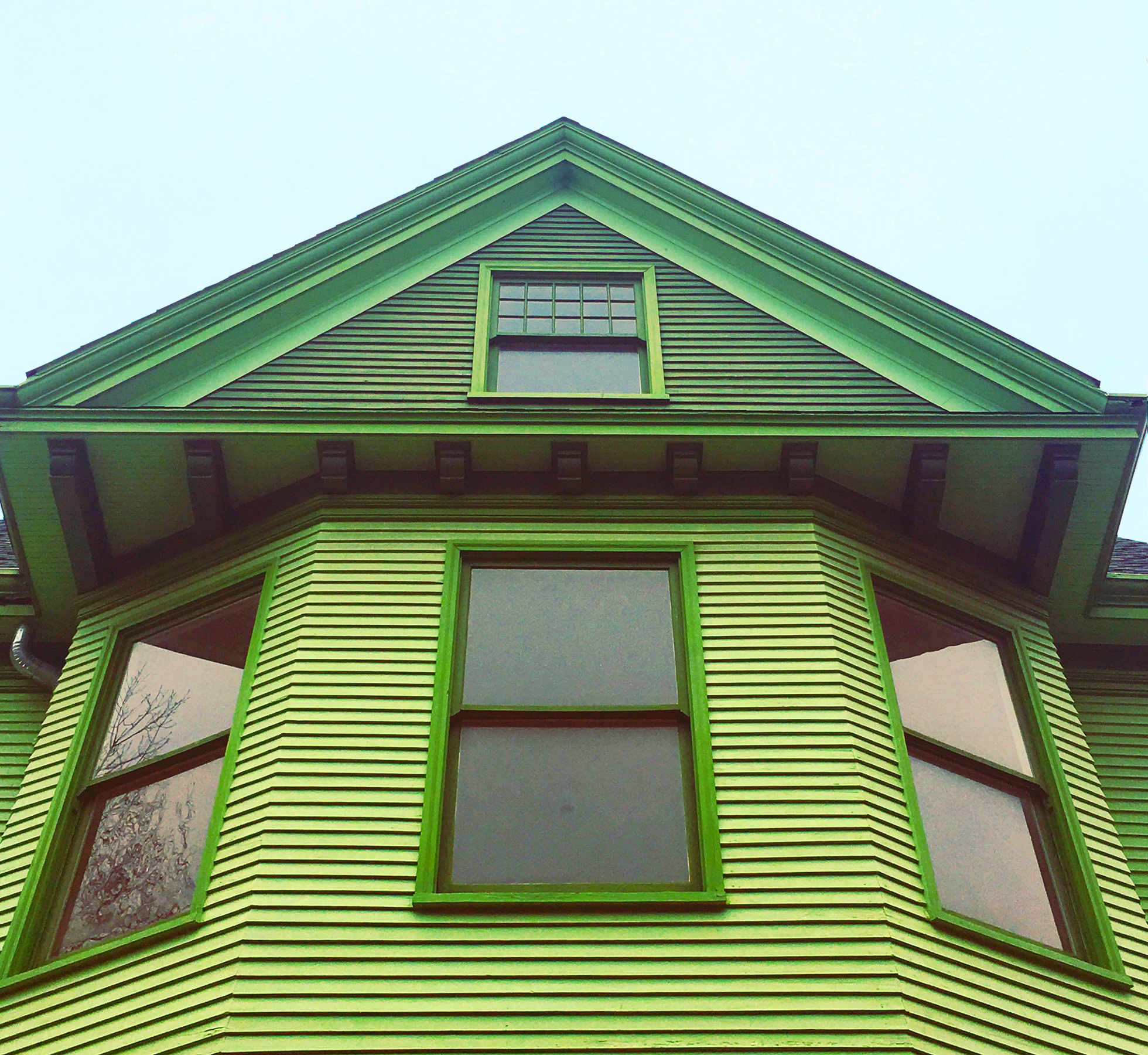 Home with bright green painted siding
