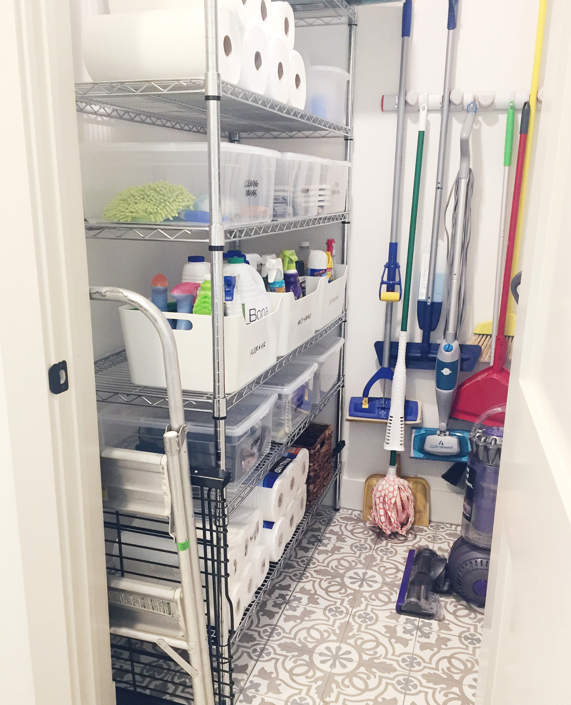 White closet packed with neatly organized cleaning supplies