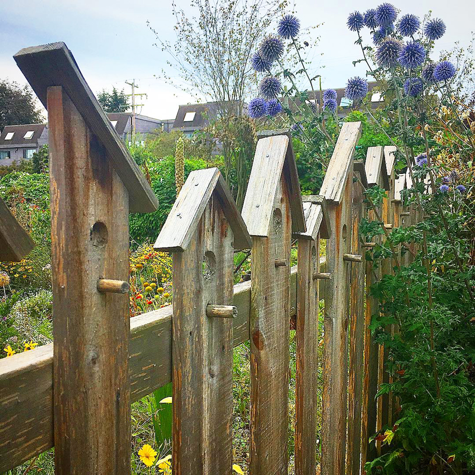 A wood birdhouse fence