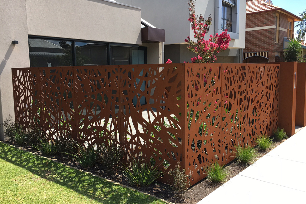 A patterned Corten steel backyard fence