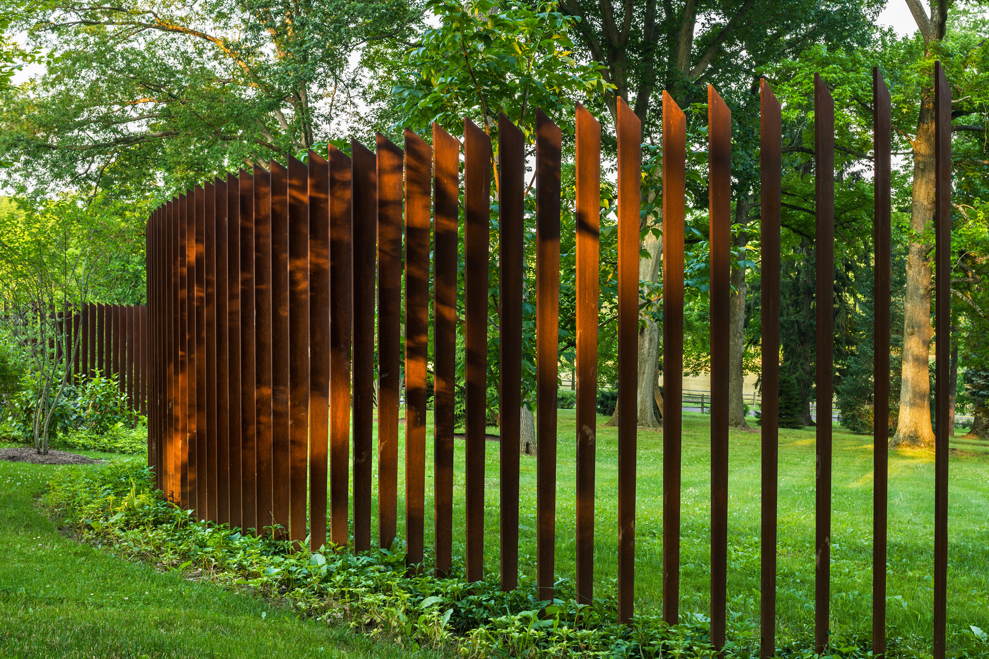 A Cor-Ten cattails sculptural fence