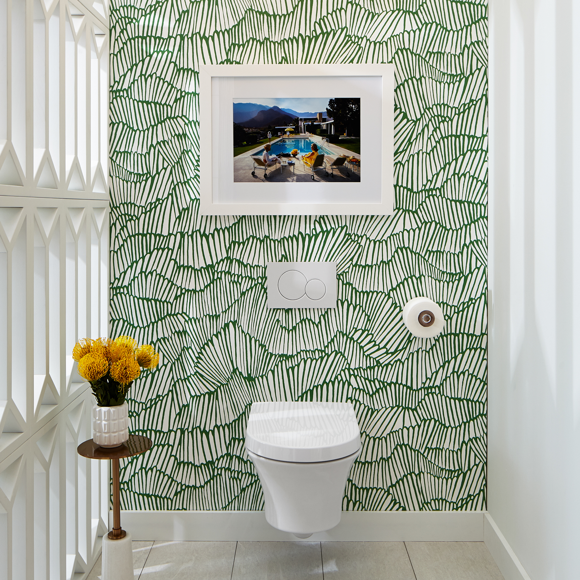 Bathroom with white/green wallpaper and wall-hung toilet
