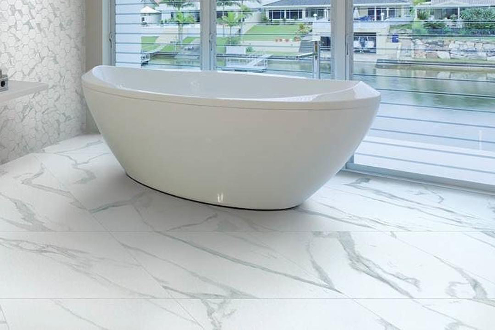 A white bathroom with tub and porcelain tiles
