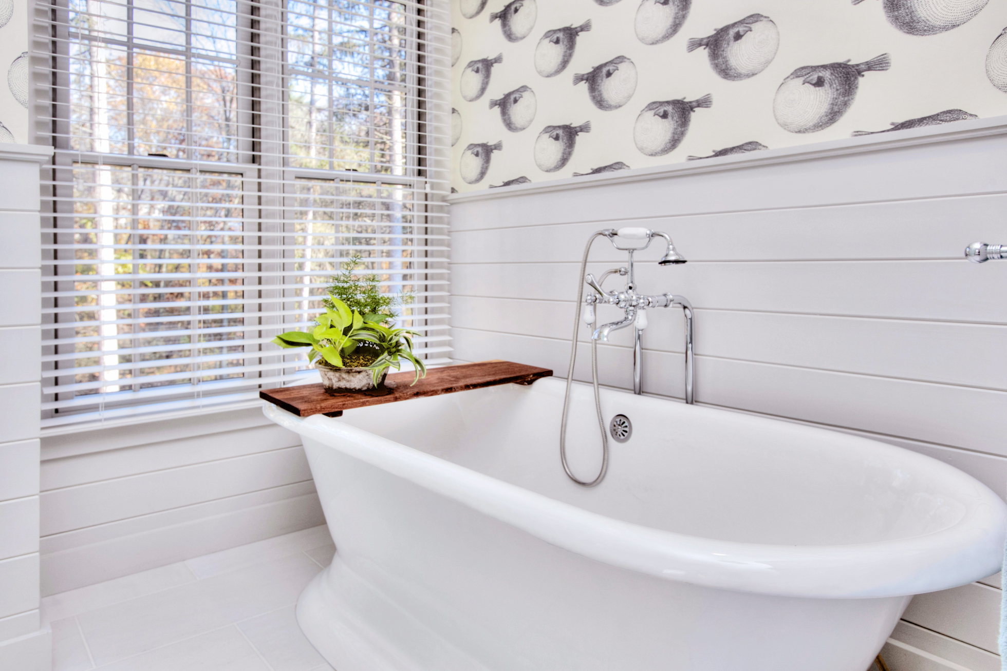 A white cast iron tub in a white bathroom