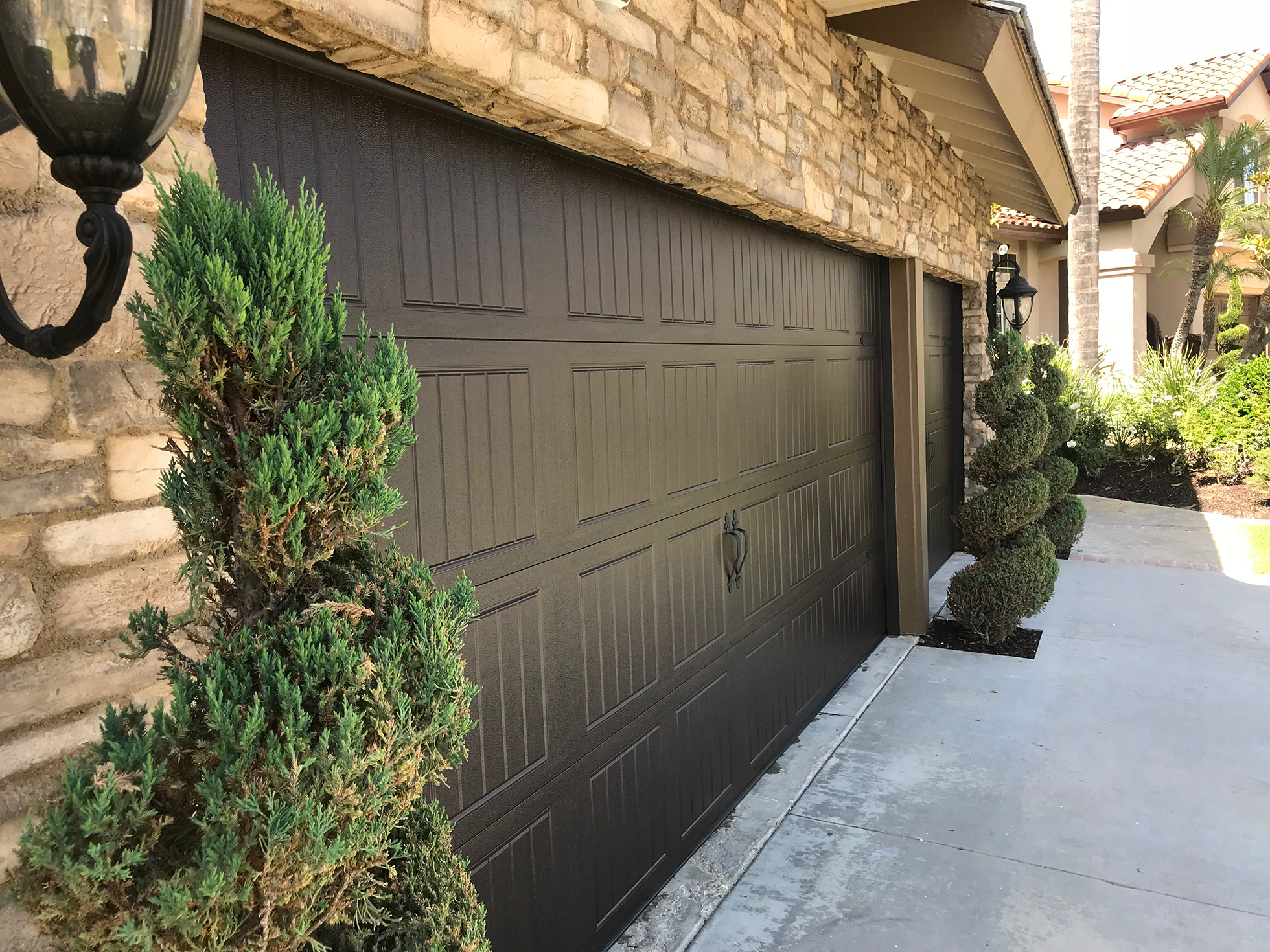 Dark brown carriage garage doors made of steel