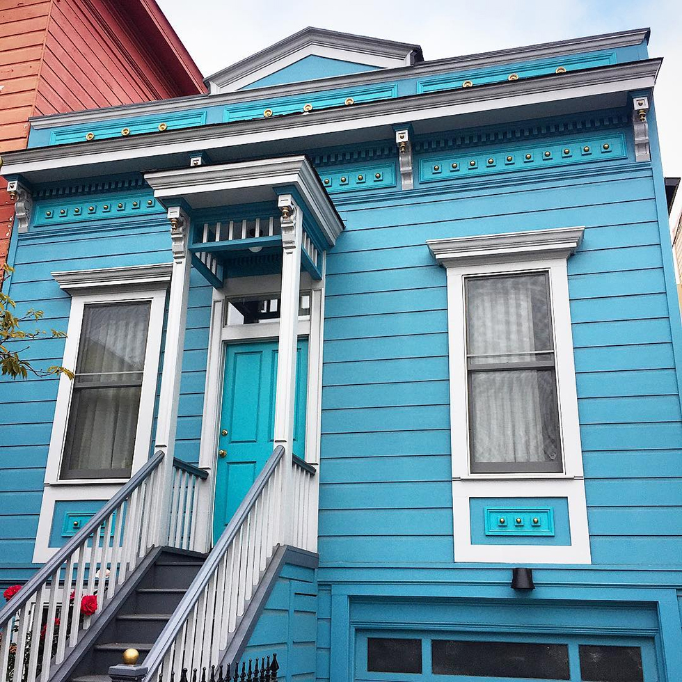 Small, light blue Victorian house with white trim