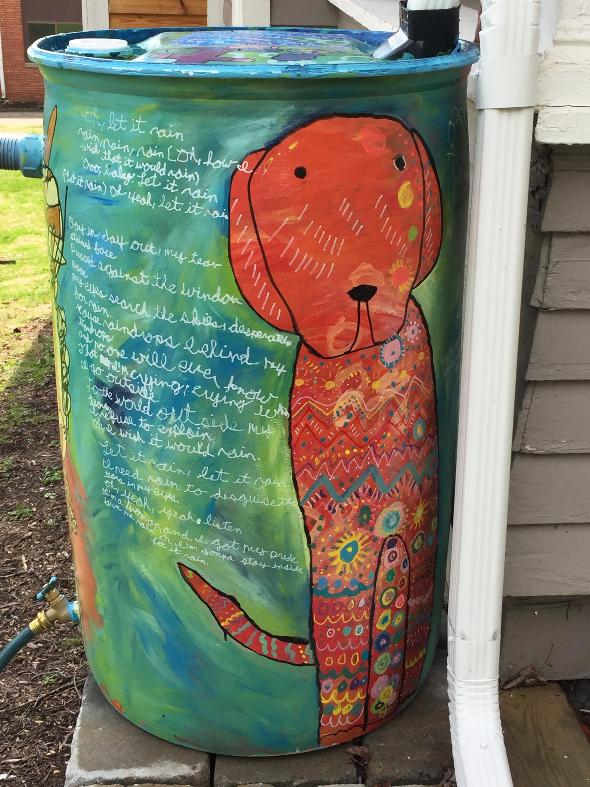 Colorful, painted rain barrel with dog illustration