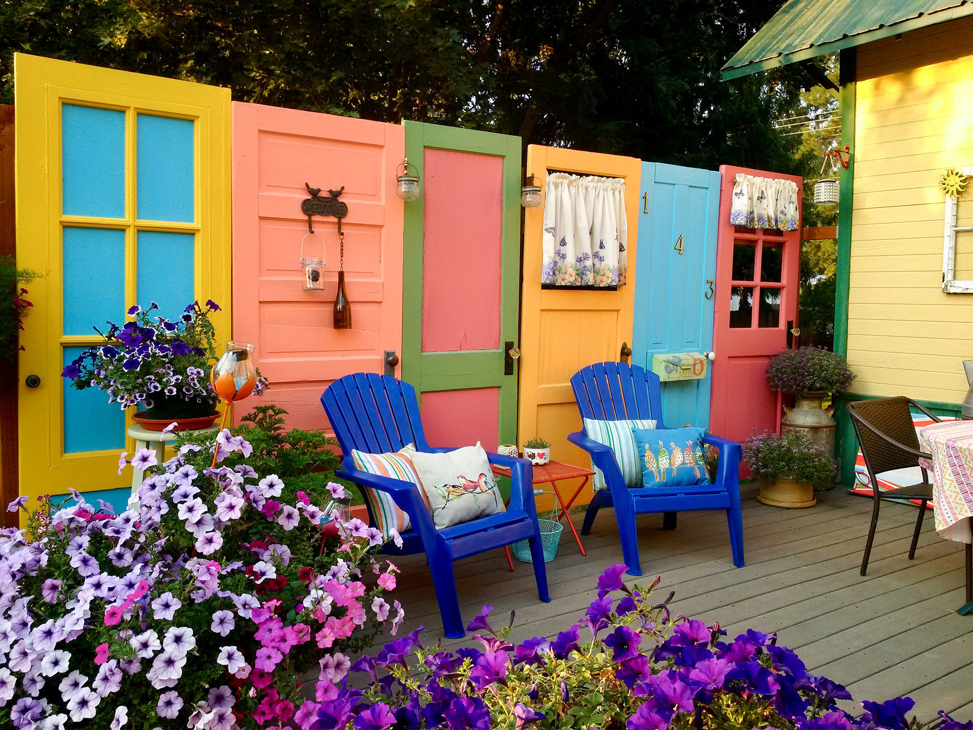 Multi-colored wood doors used as deck privacy screen