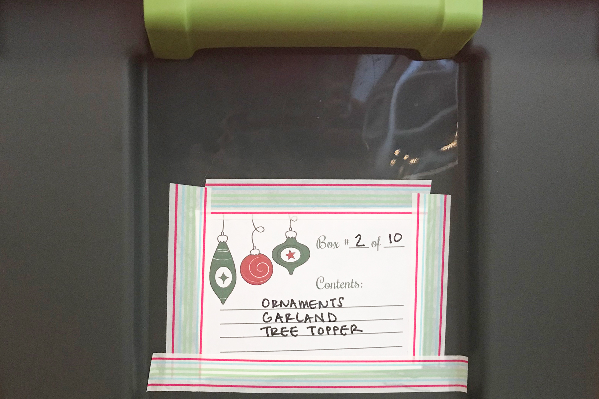A gray Tupperware with a note of holiday supplies enclosed