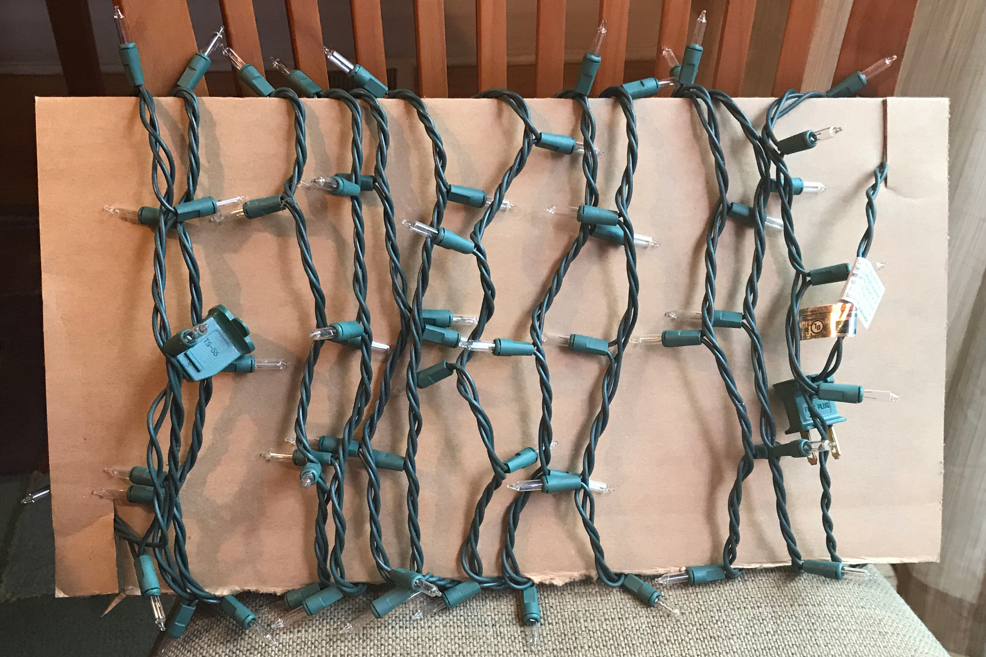 Holiday lights wrapped around a piece of cardboard