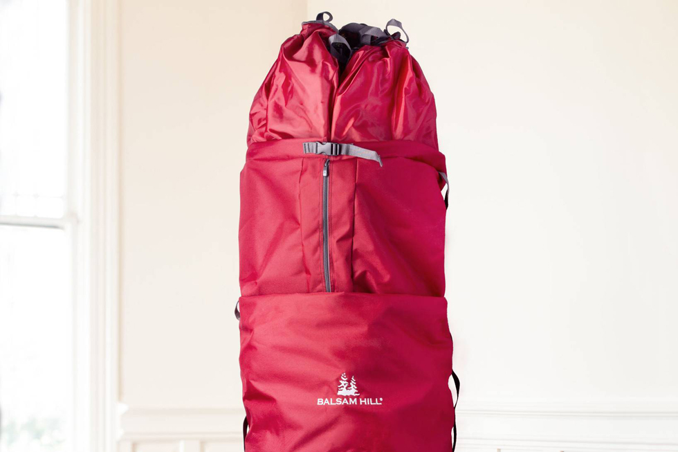 A tall red bag that conceals fake Christmas tree