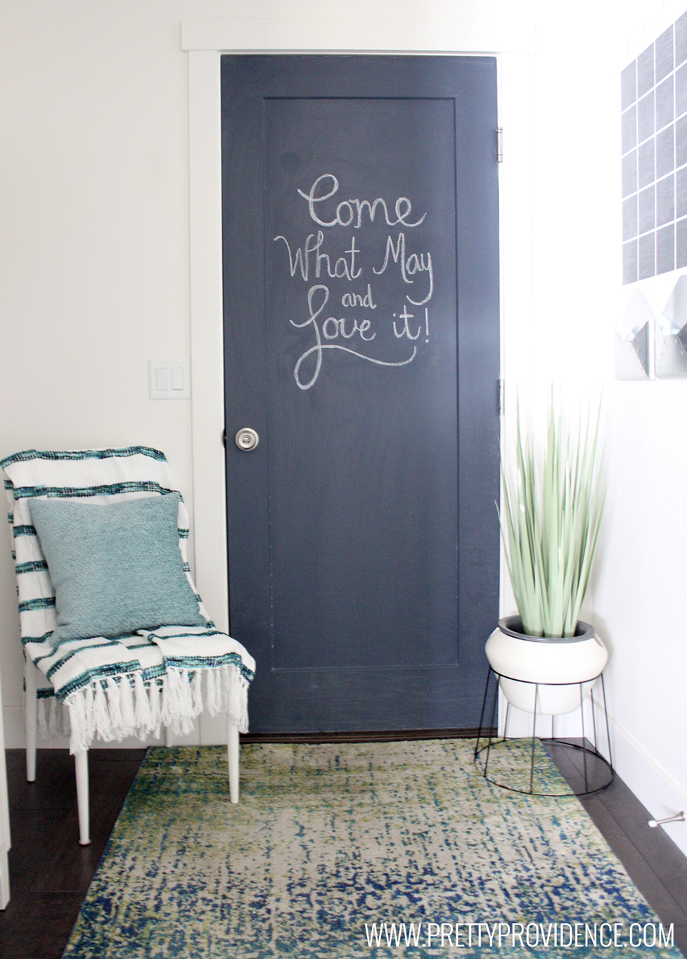 Chalk door that says, "Come what may and love it!"