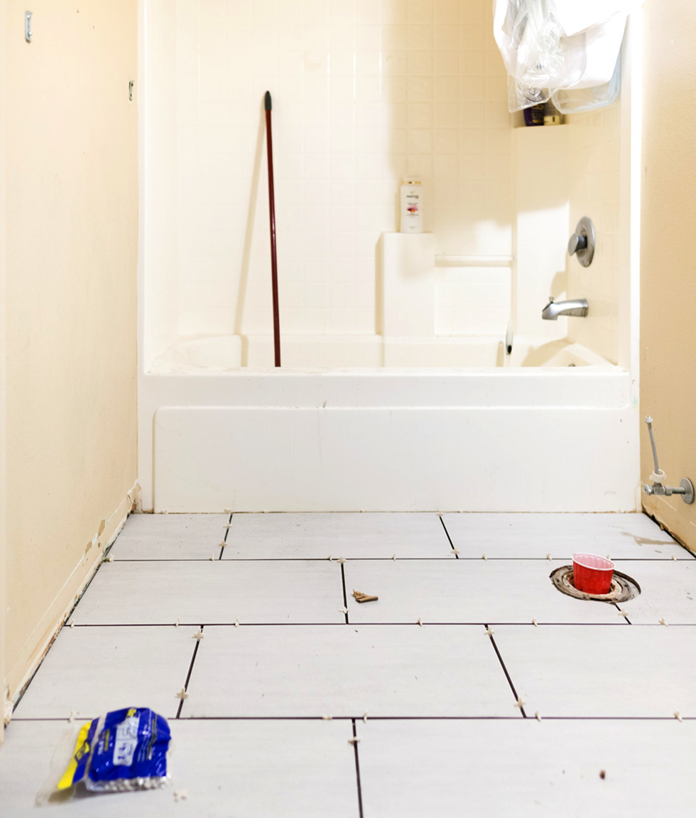 Freshly laid white tile as part of a bathroom renovation
