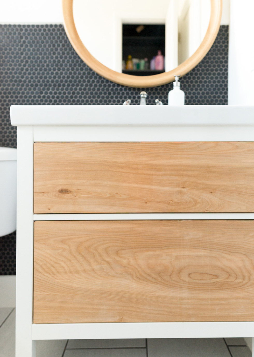 Close up of white bathroom vanity with natural wood details