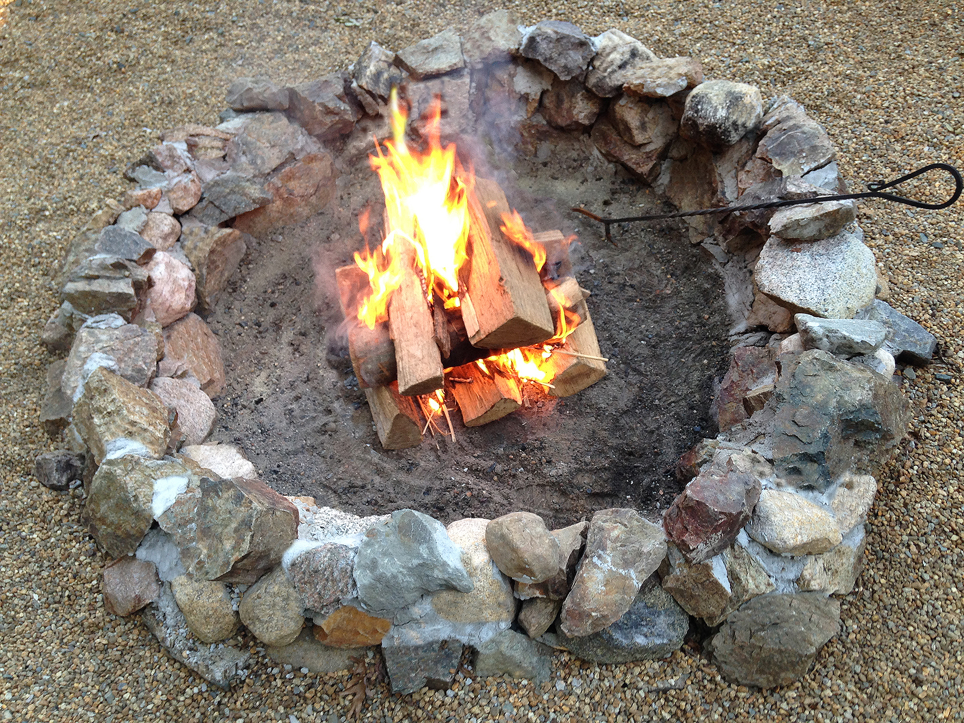 A rock fire pit with flame