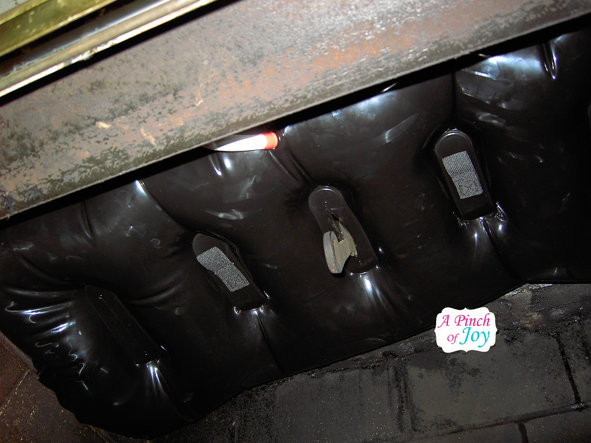 Underside view of black fireplace balloon wedged in chimney