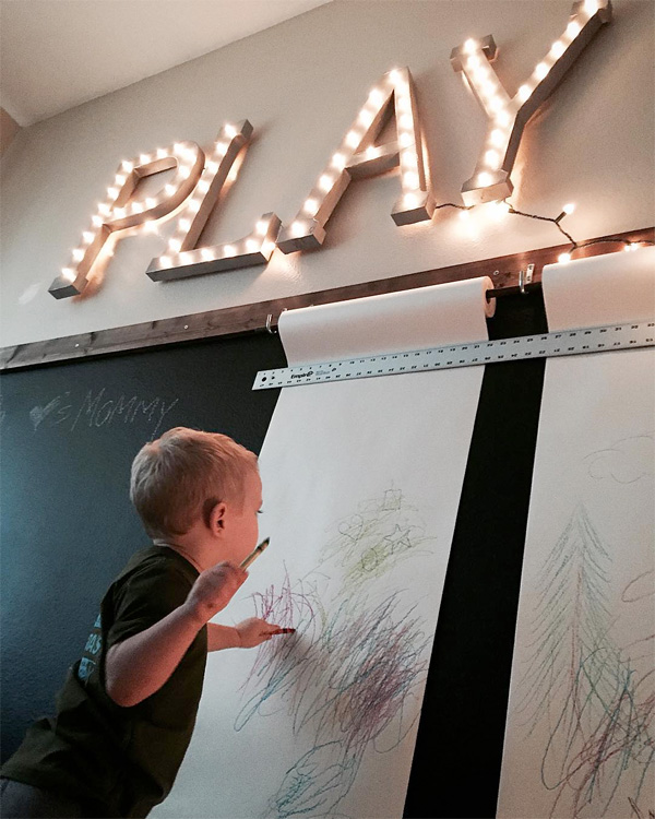 Drawing on a chalkboard wall in a home playroom