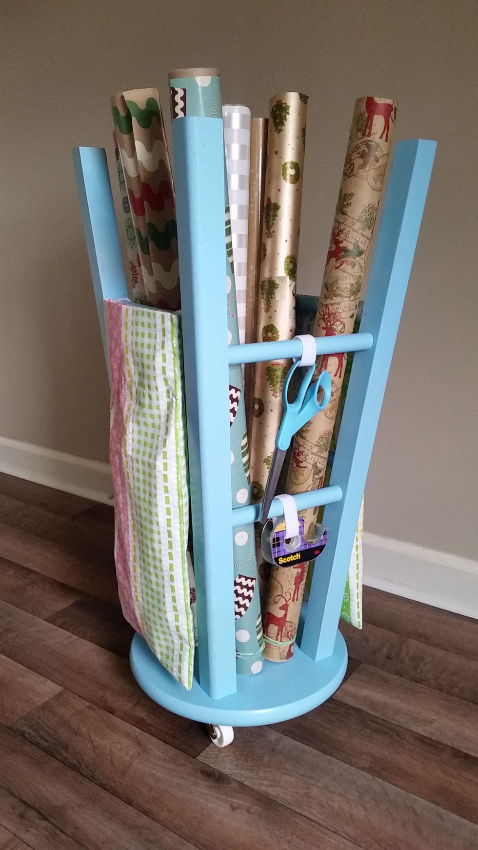Gift wrap organizer created from a wooden stool