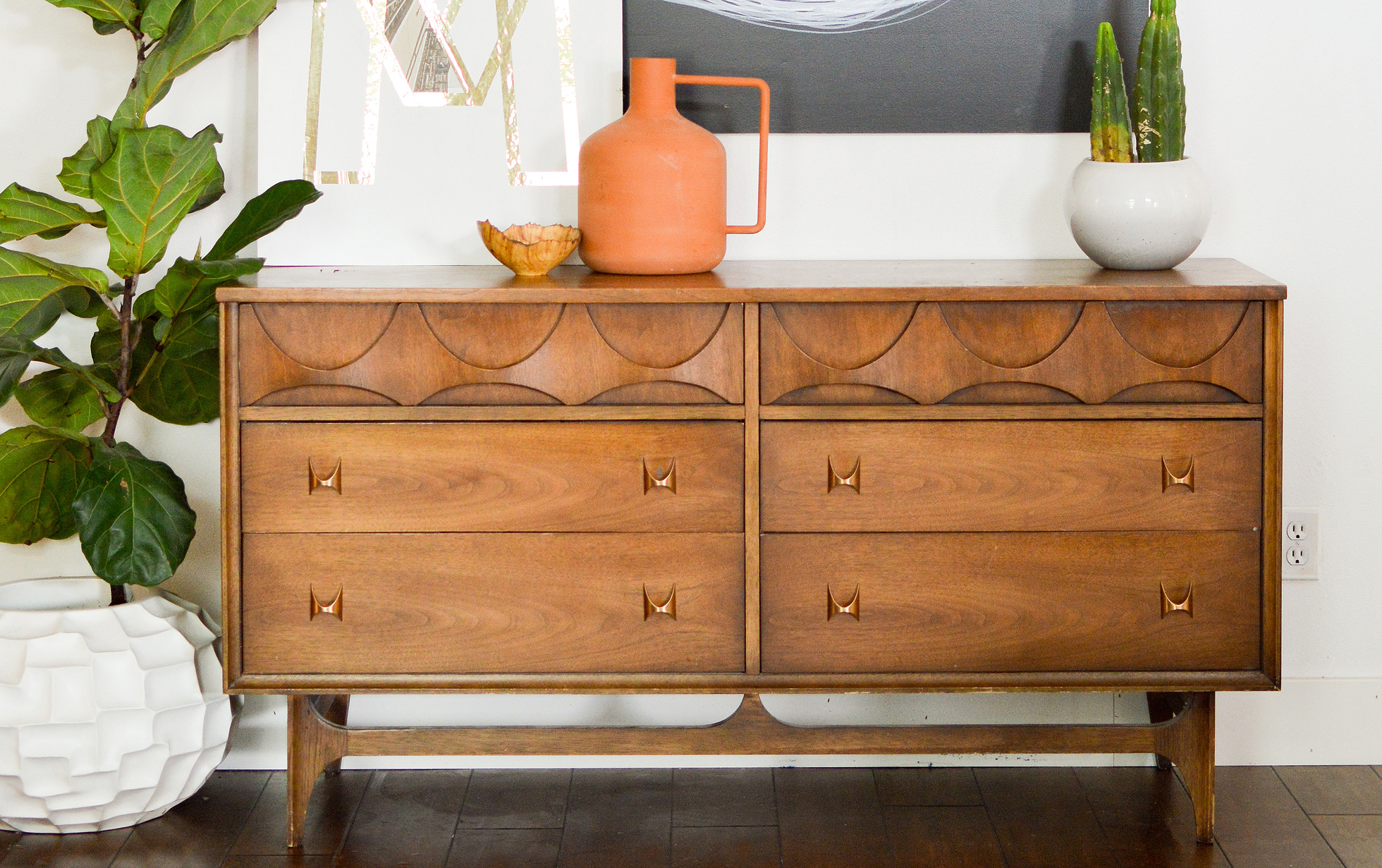 A refinished wood dresser in a bright living room