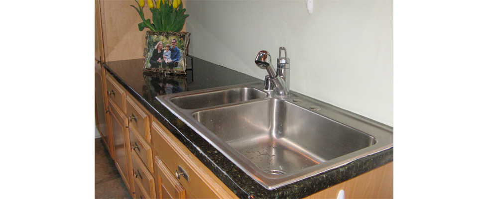 Faux granite counter with picture frame and yellow flowers