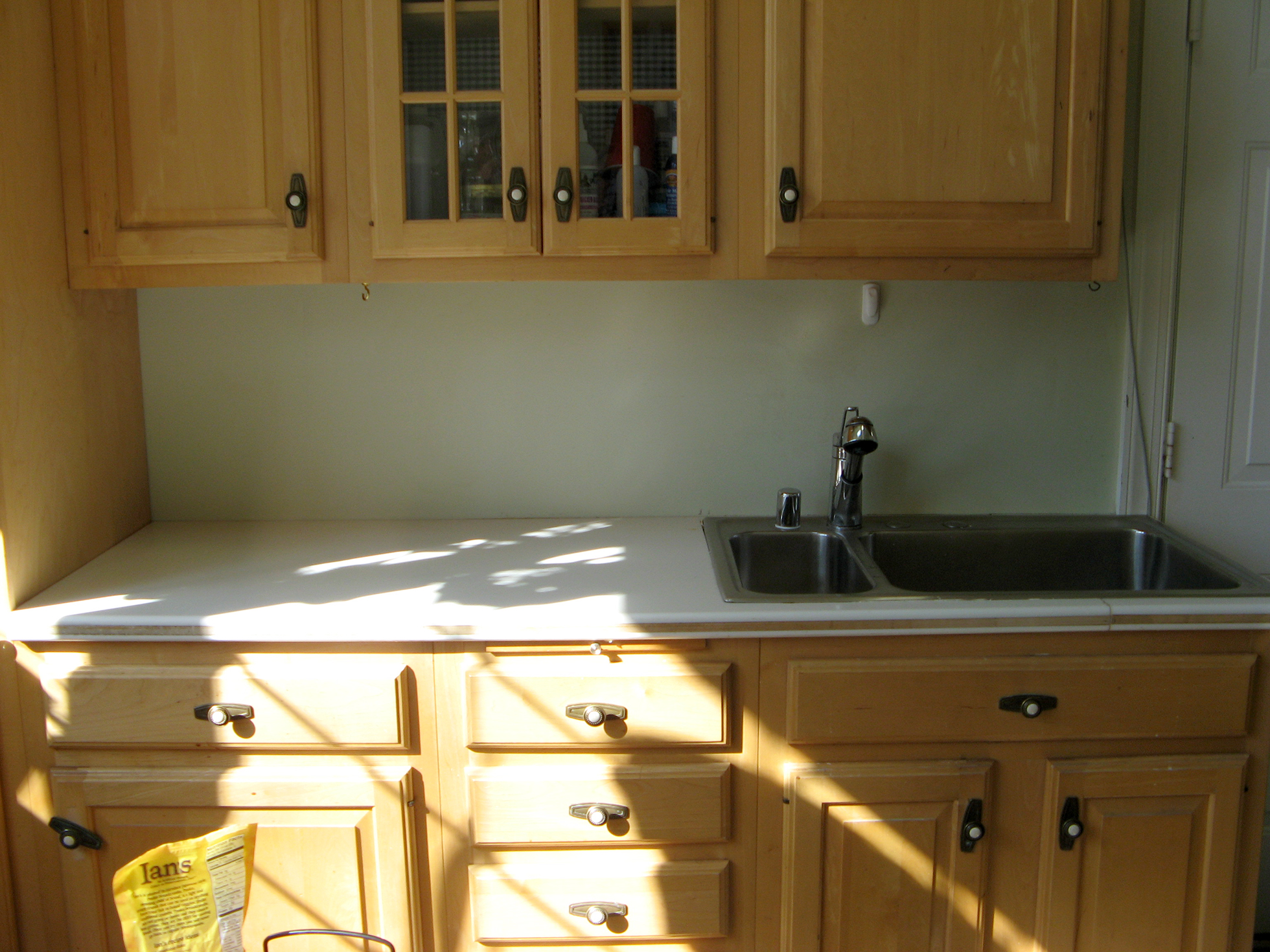 Blond cabinets with faucet | Faux Granite Countertops
