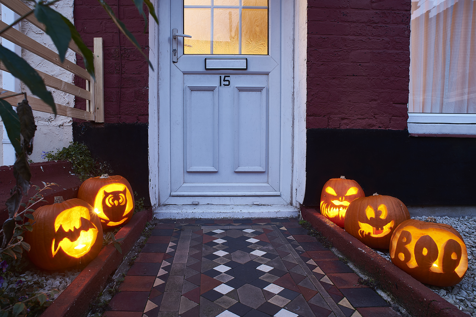 Brick path lined with jack-o-lanterns lit with LED candles