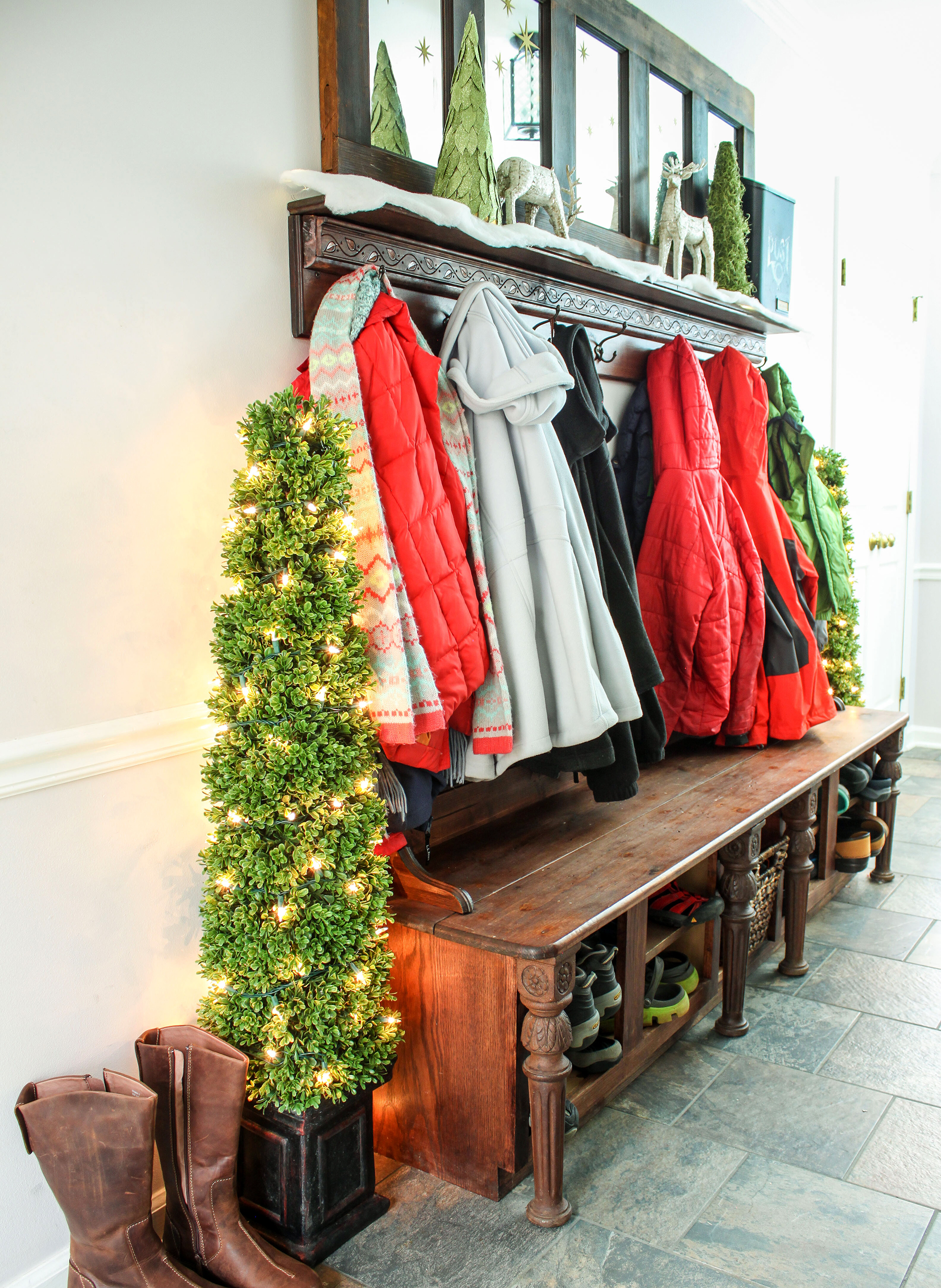Entry way filled with coats and shoes decorated for holidays