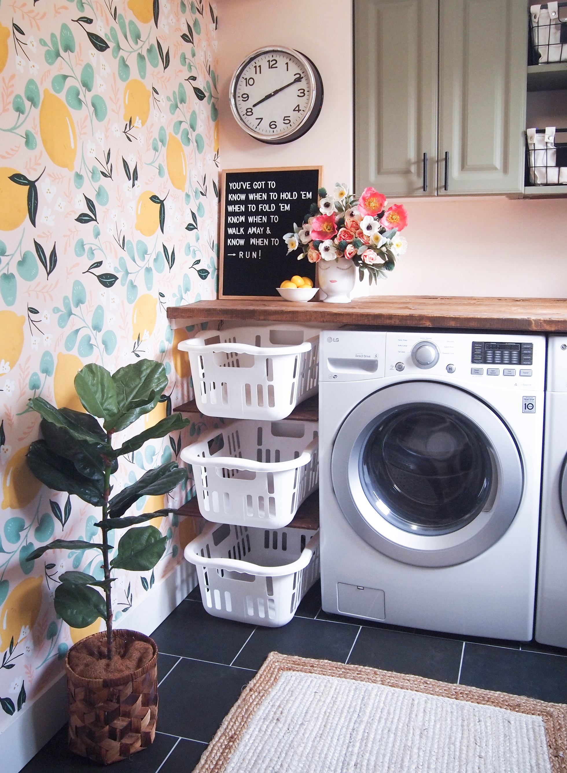 Sunny laundry room with counter above washer and dryer