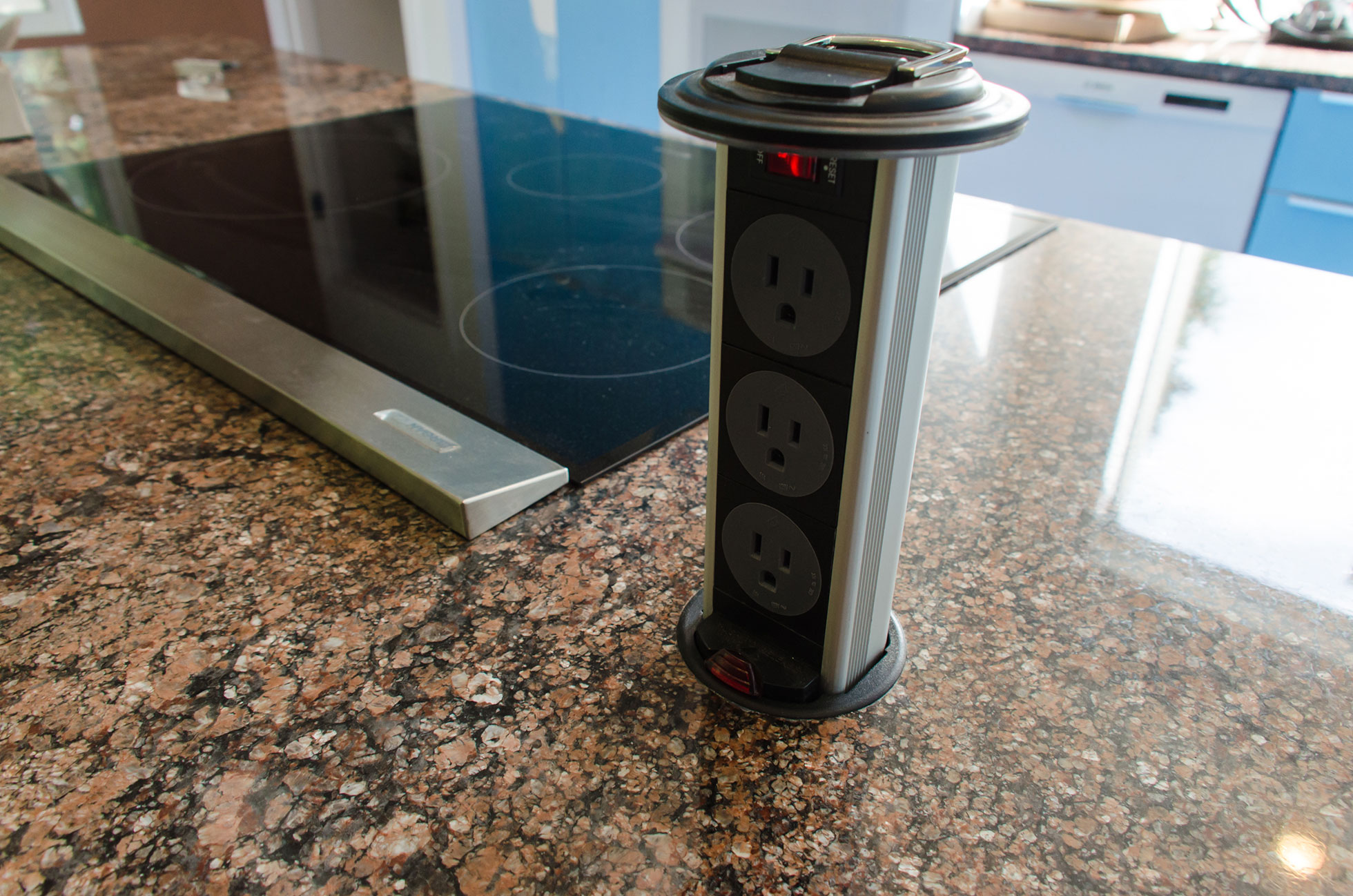 Kitchen island with pop-up power outlets