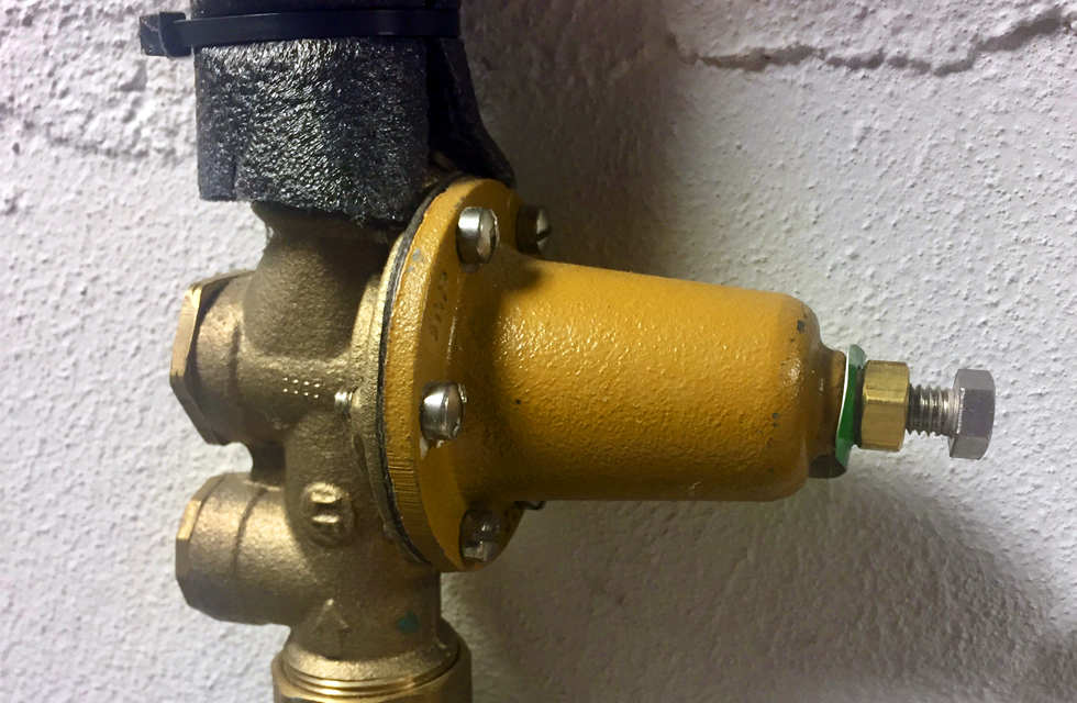 Water pressure regulator in a home basement