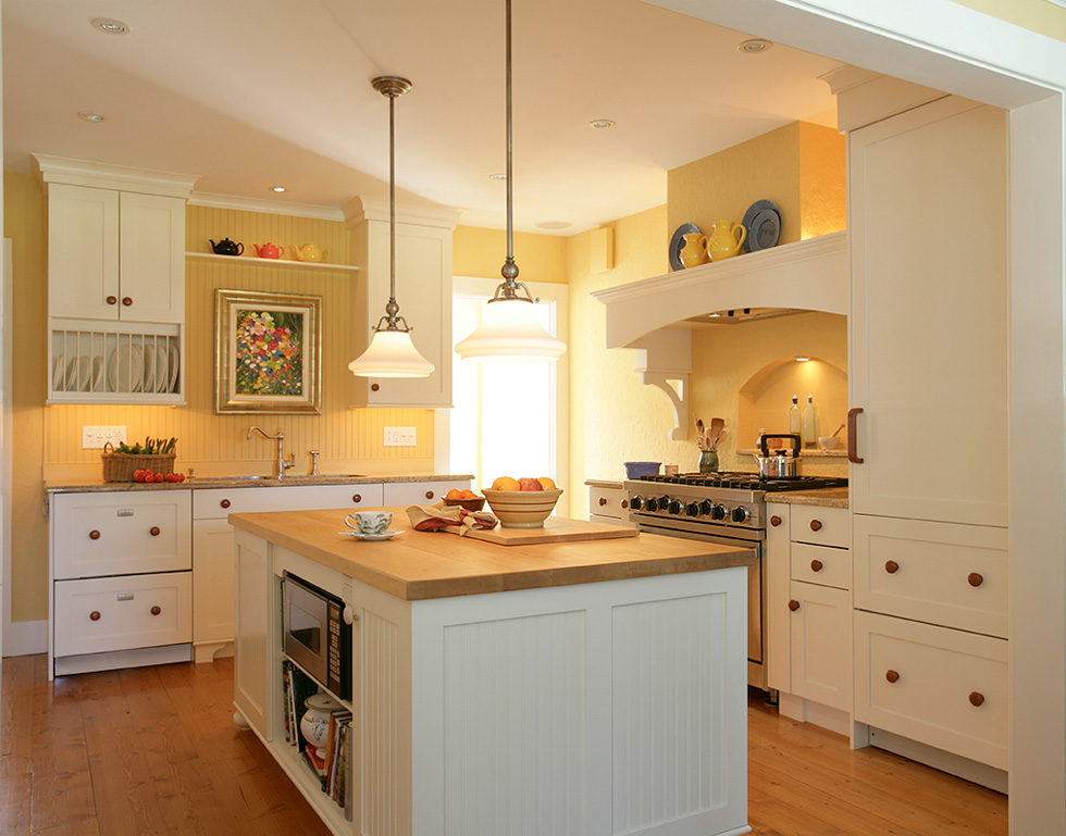 Kitchen staged with a bowl of fruit on the counter
