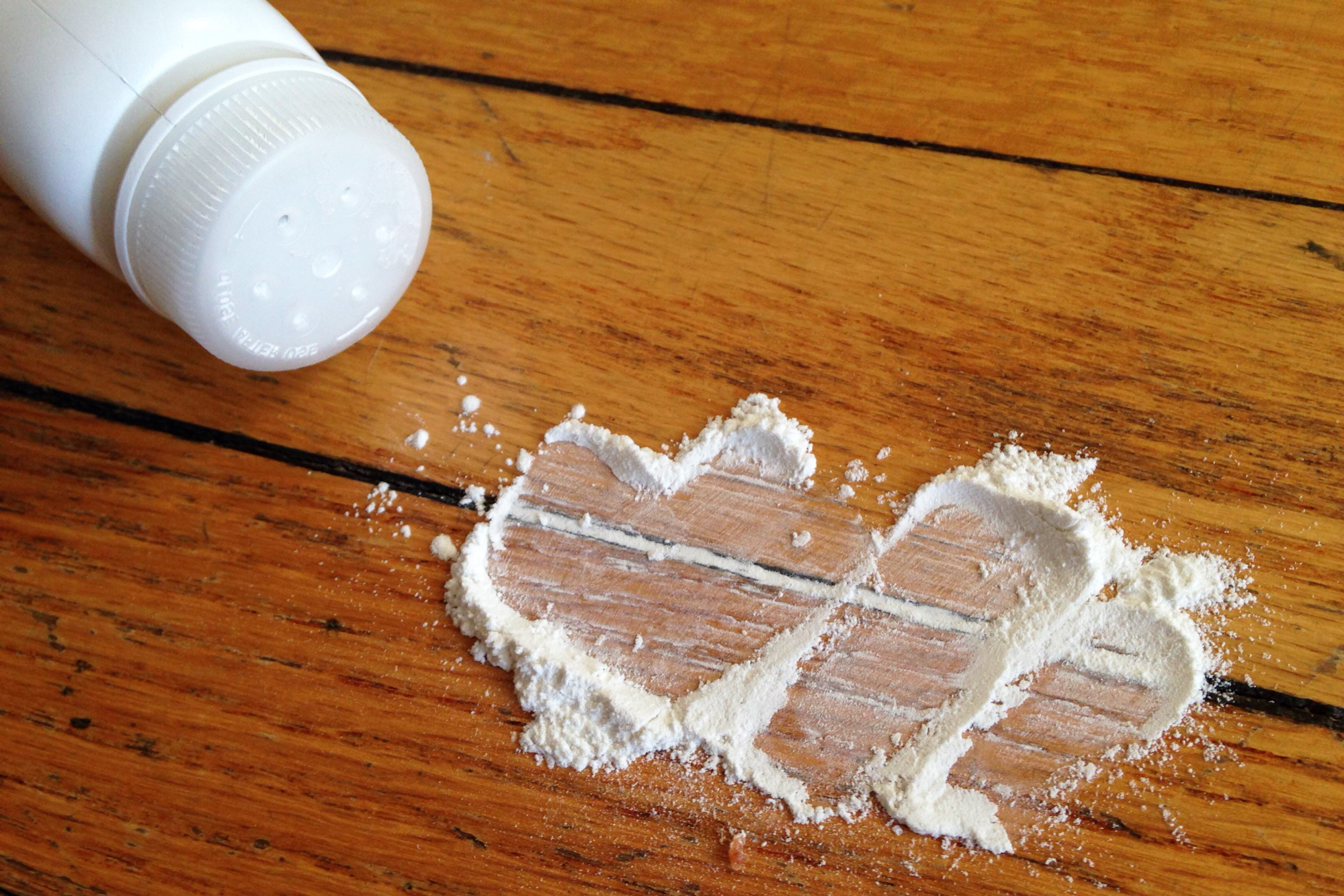 Fixing a squeaky wood floor by sprinkling talc