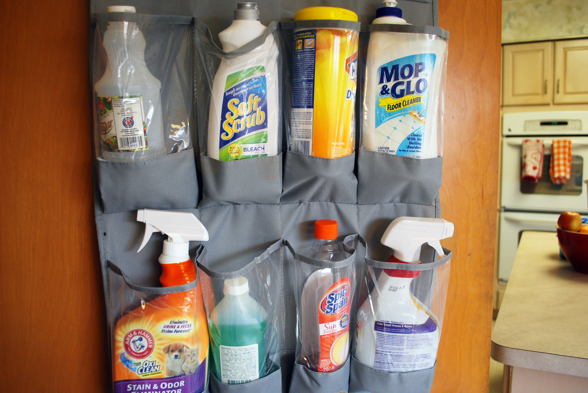 Shoe caddy filled with cleaning supplies in a kitchen
