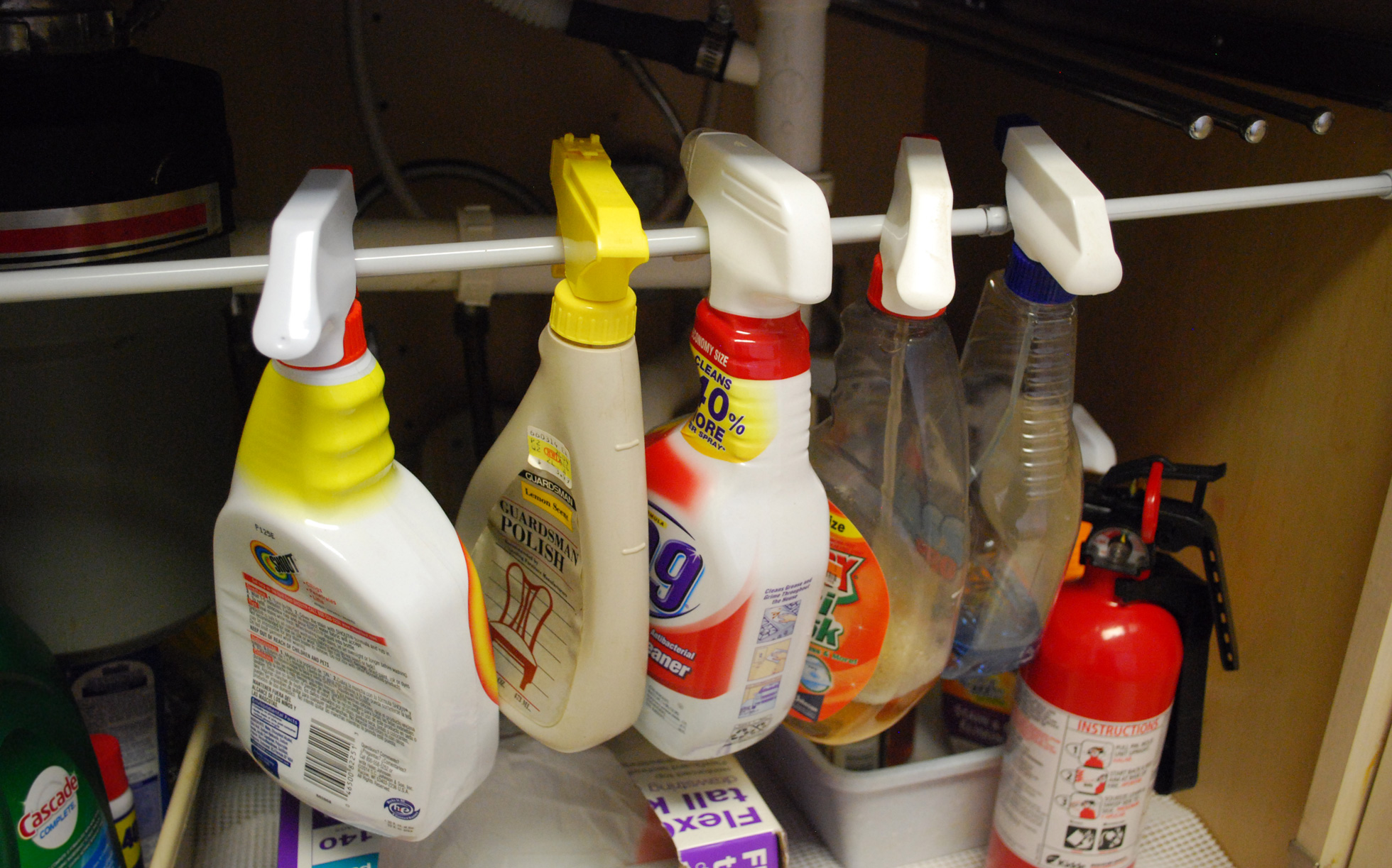 Tension rod used to organize spray bottles