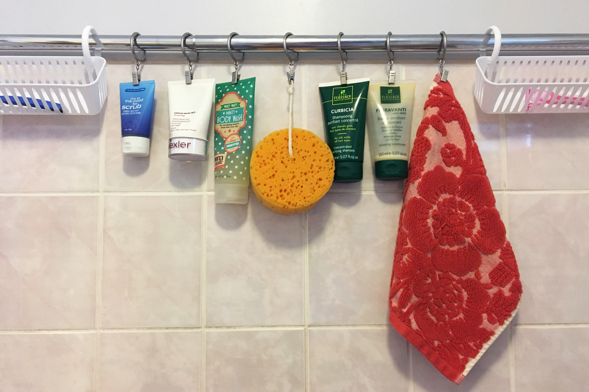 Toiletries hanging from a second shower rod