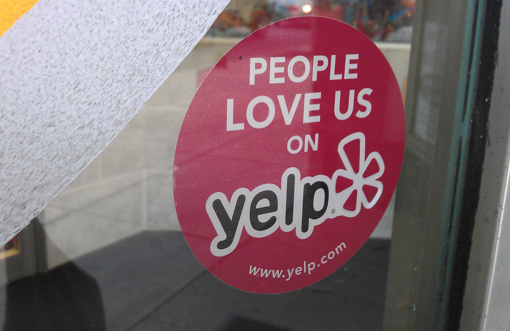 Yelp sticker on a store window