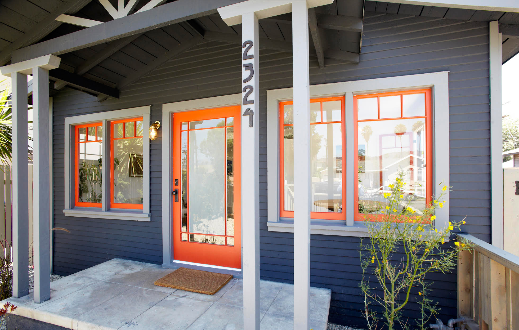 Blue painted house with bright orange trim
