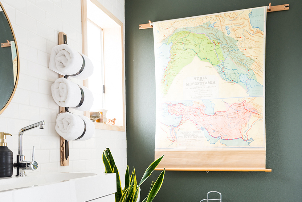 Updated bathroom with wood floors and green wall