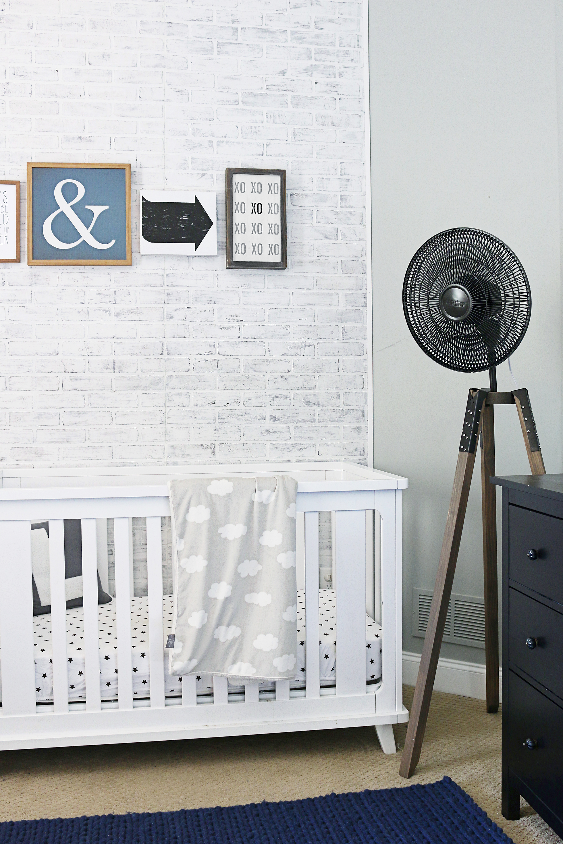 A nursery with gray-painted brick walls