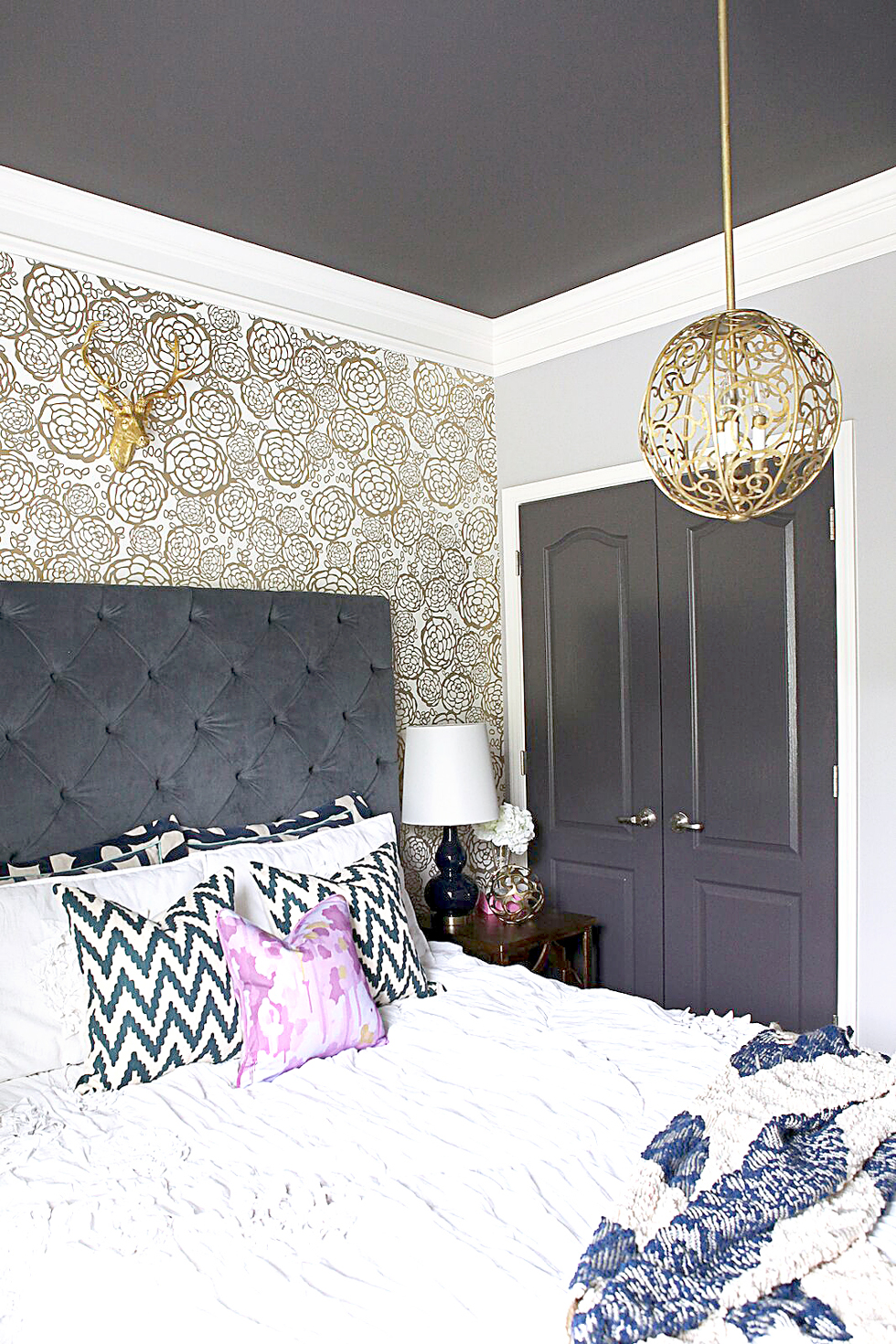Gold and white wallpapered bedroom walls