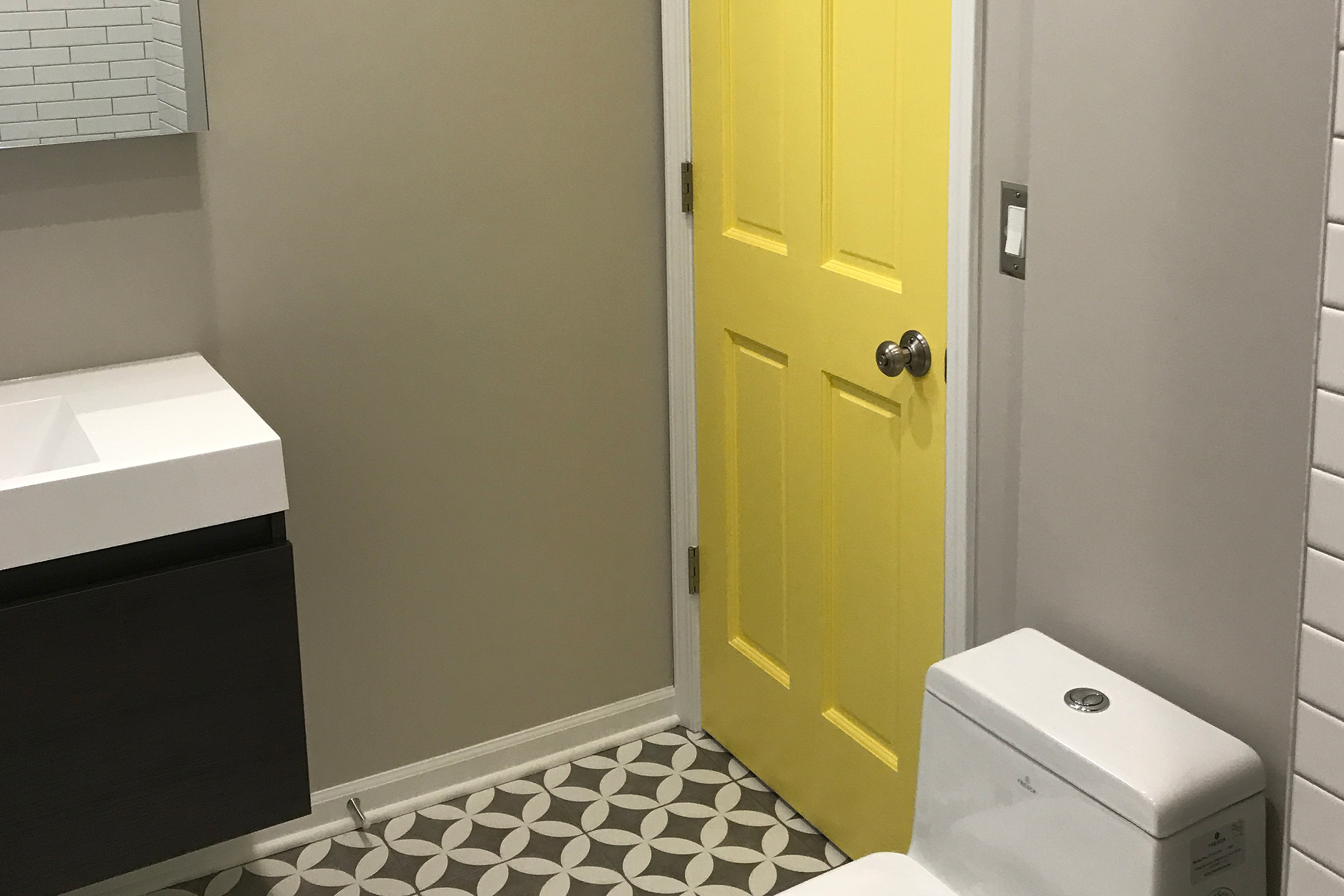 A yellow door in a bathroom