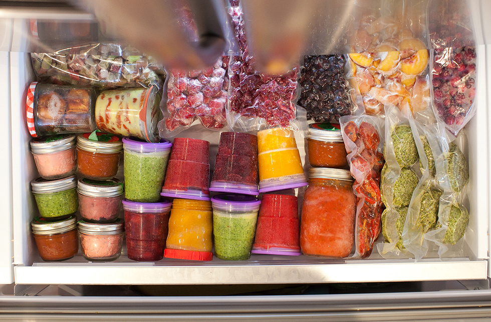Plastic bags with frozen fruit in a freezer