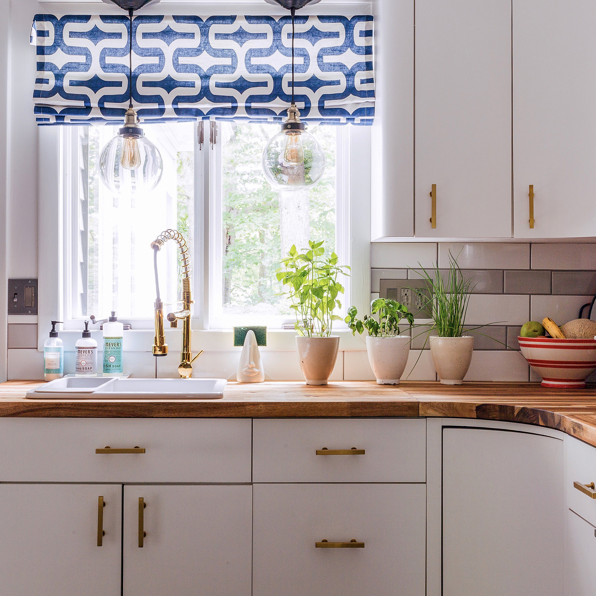 White kitchen with pendant lights installed using light kit