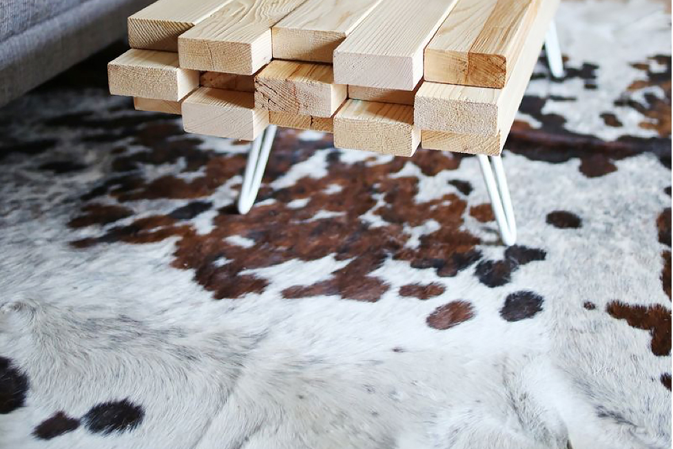A two-by-four coffee table and cowhide rug