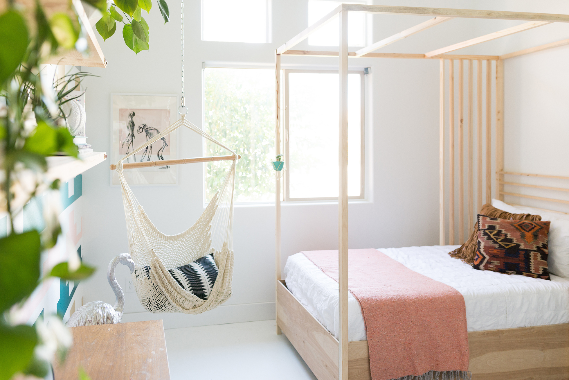 Bright bedroom with wood frame canopy bed