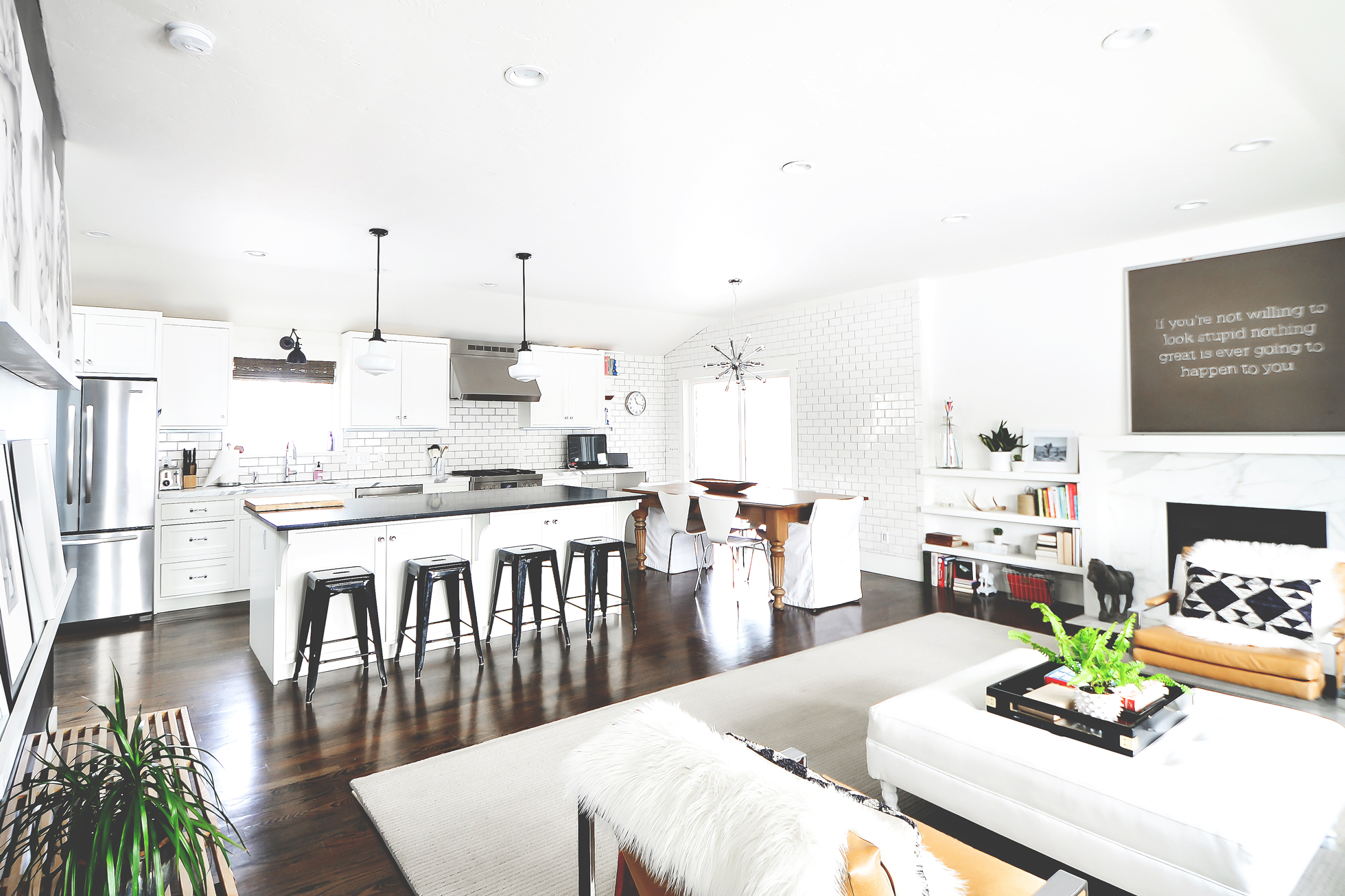 Wide shot of bright white living room, kitchen